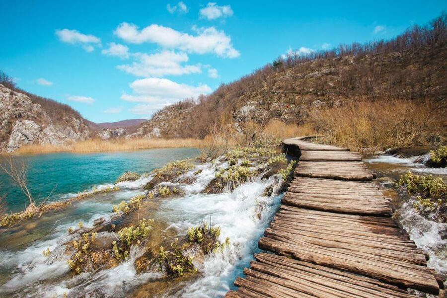 From Split or Trogir: Plitvice Lakes Guided Full-Day Tour - Walking the wooden paths beside the falls