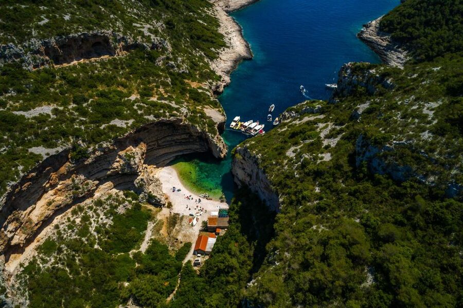 From Split: Private Day Trip to Blue Cave and Islands - Stiniva Beach on Vis, framed by high cliffs