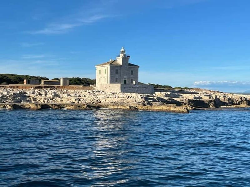 Pula: Dolphin-Watching Cruise at Sunset with Dinner & Drinks - Pula’s Lighting Giants close the evening